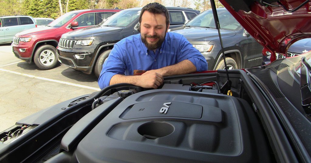 Jace looks at the engine of the 2017 Jeep Grand Cherokee Trailhawk