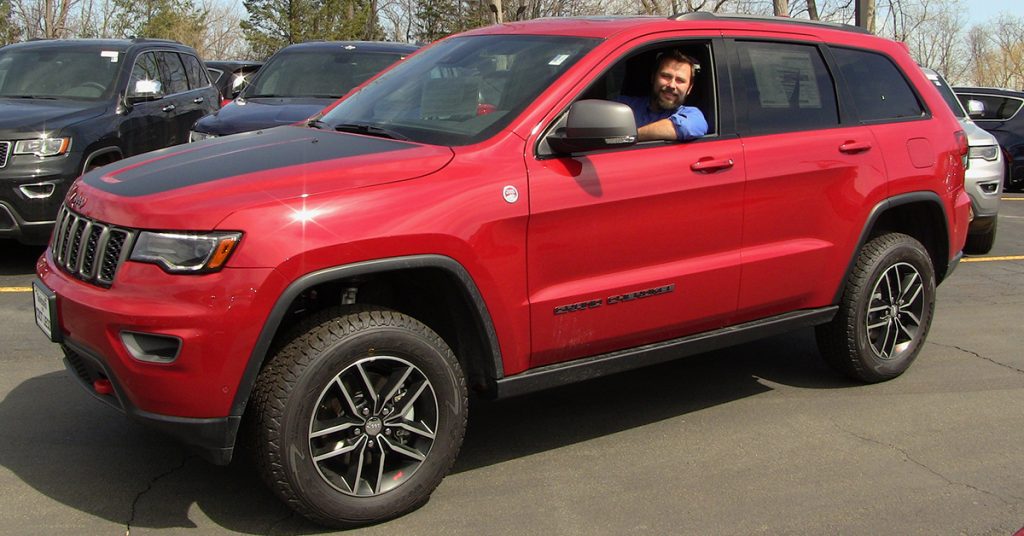 Jace sits in the drivers seat of the 2017 Jeep Grand Cherokee Trailhawk