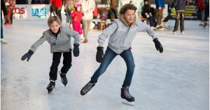 Two boys ice skating at a skating rink | Goldstein Chrysler Jeep Dodge RAM