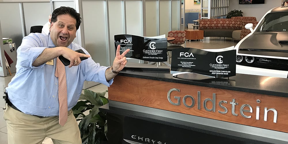 Sales manager poses with Customer First Award