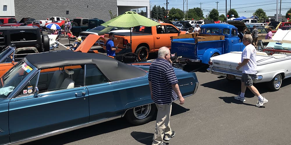 People walk among the MOPAR and Jeep vehicles.