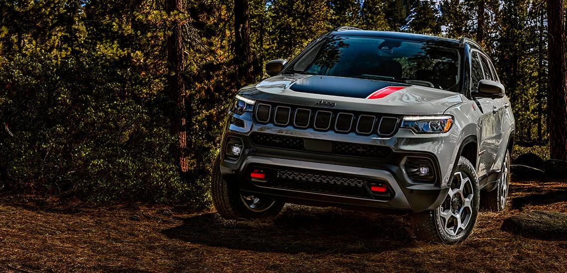 New 2022 Jeep Compass Trailhawk in woods for adventure